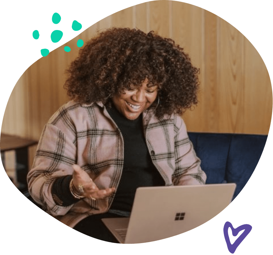 Woman smiling down at her laptop after receiving a Thankbox