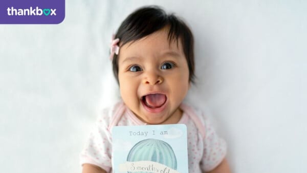 New born baby with birthday card