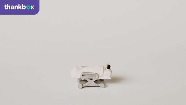 A miniature hospital trolley and patient for a funny get well soon message