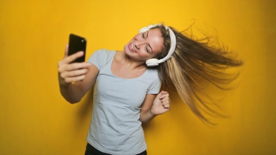 Photography of a Woman Listening to Music