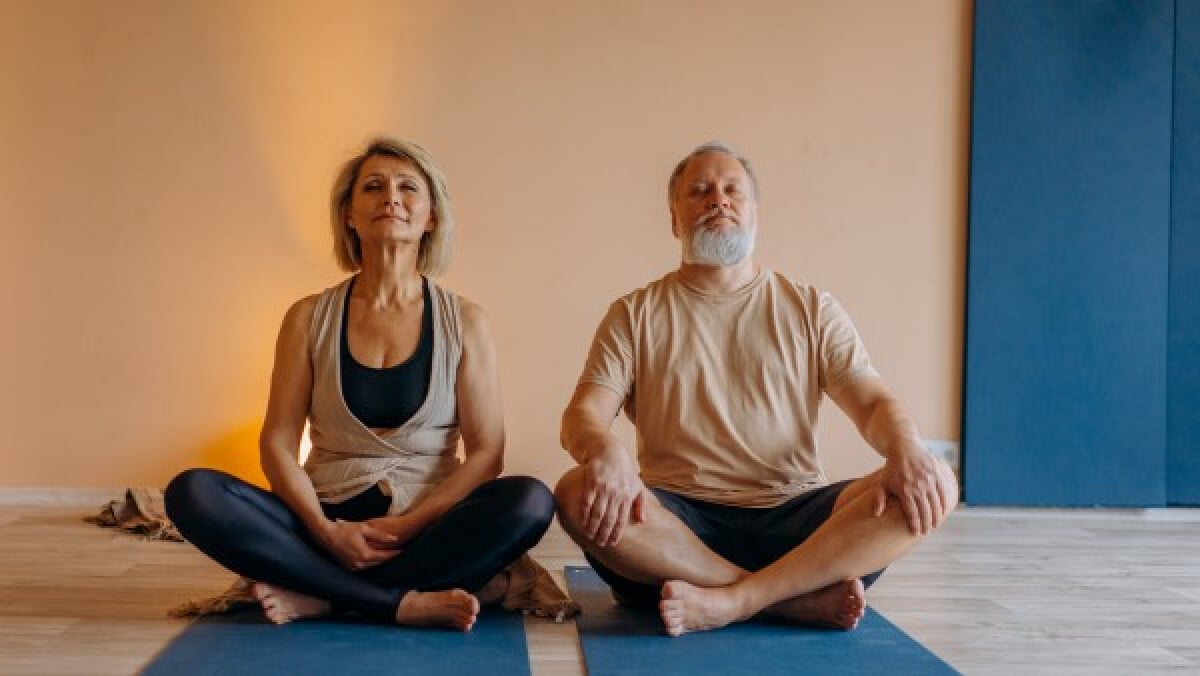 Elderly couple doing yoga