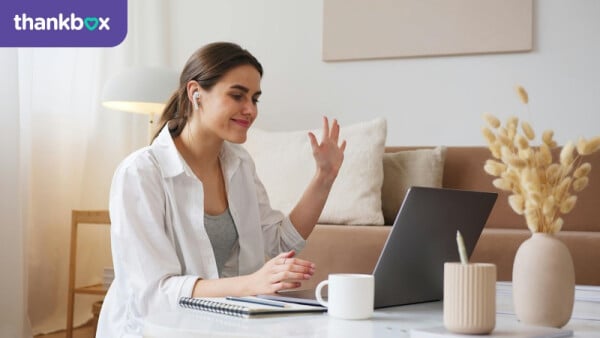 Cheerful woman having video call via laptop