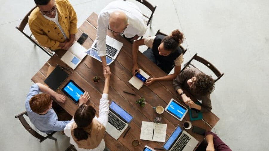 People doing handshakes in a meeting