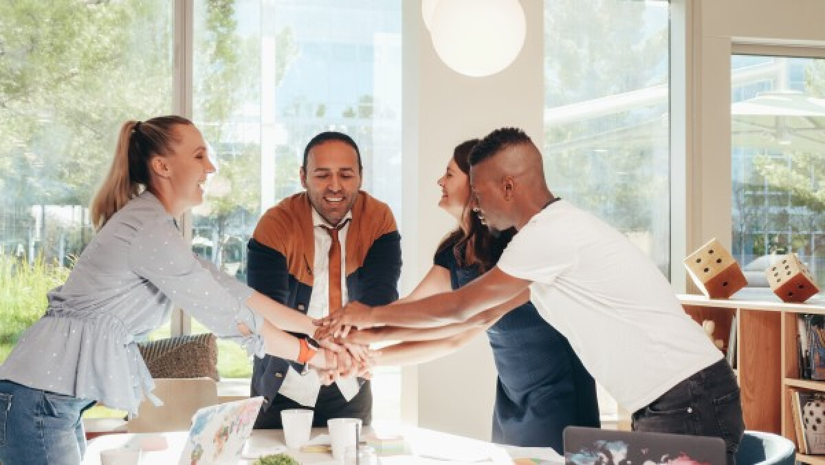 Cheerful colleagues greeting each other in an office