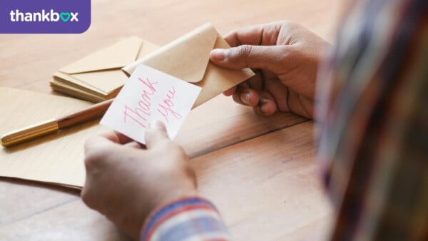 Hands Holding Thank you Note and Envelope