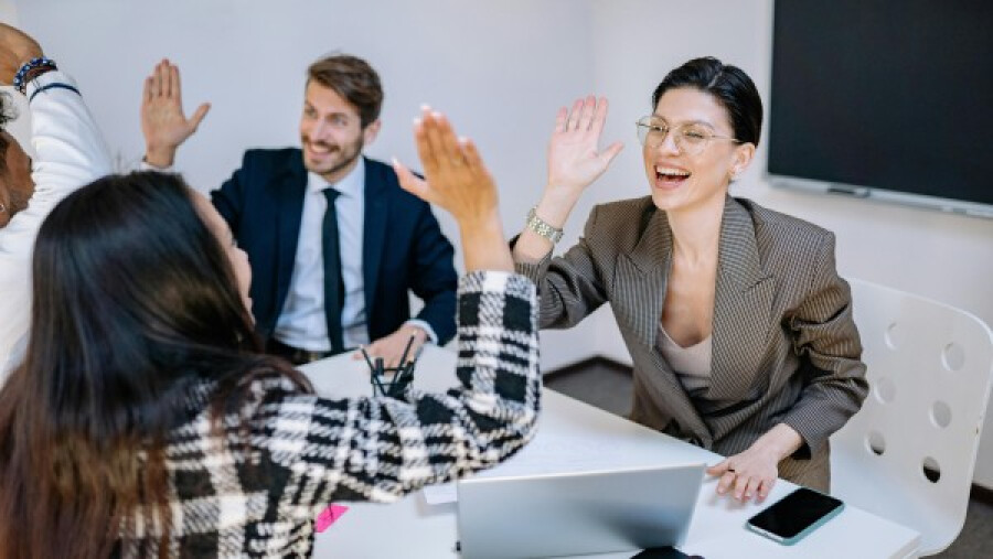 Happy employees doing high fives