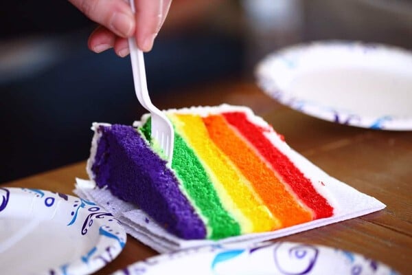 A slice of rainbow cake to celebrate an LGBTQ+ birthday